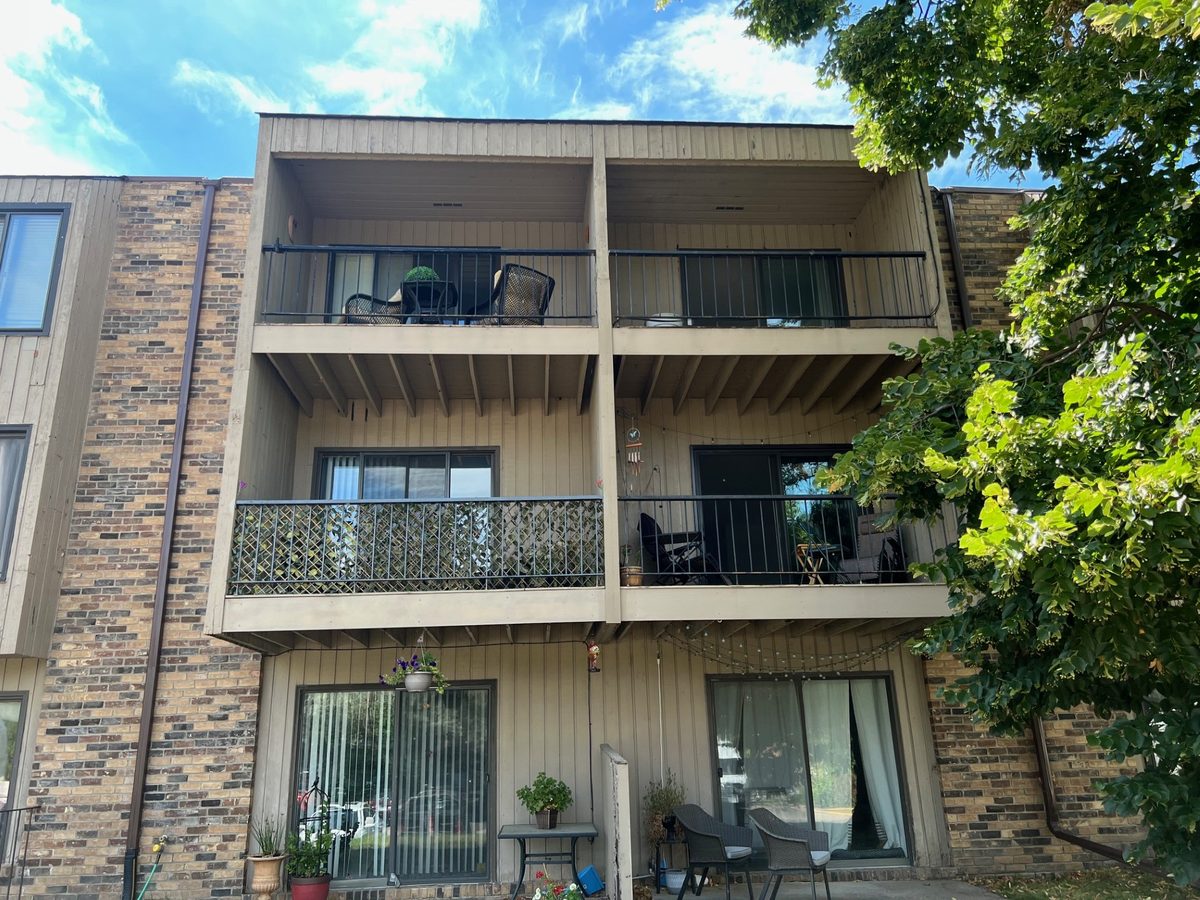 Bridgewalk before the envelope restoration: weathered vertical wood siding and aging balconies