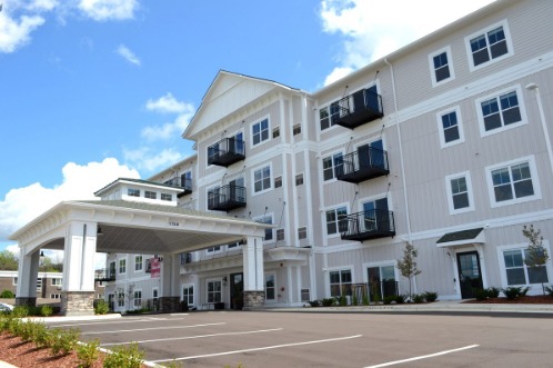 The Hendrickson exterior with a covered drop-off entry and private balconies